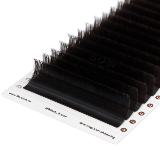 Closeup of Dark brown eyelash extension from a Dutch angle in lash tray